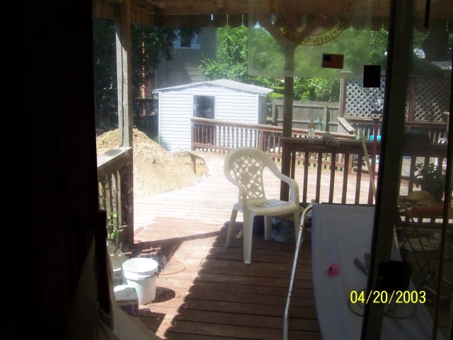 This is the patio deck, from the upper level of the house.  It needs clearing.  Note the large pile of dirt that's where our Pool should be.