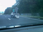 Yes, I saw this today on the way back from lunch.  I literally could not believe I was seeing it.

My cameraphone just paid for itself.

This is the rear view.  You can see the Southern State Parkway exit ramp ahead.  He got on it.